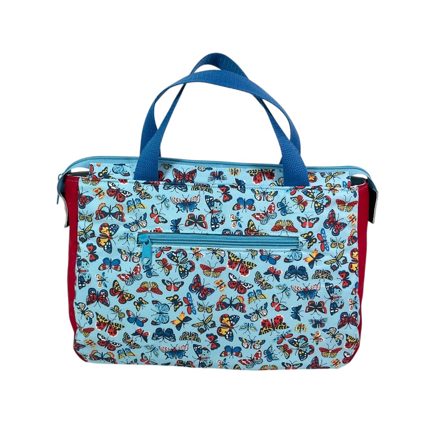 large toiletries bag made from  Liberty fabric, with handles and pockets in and 