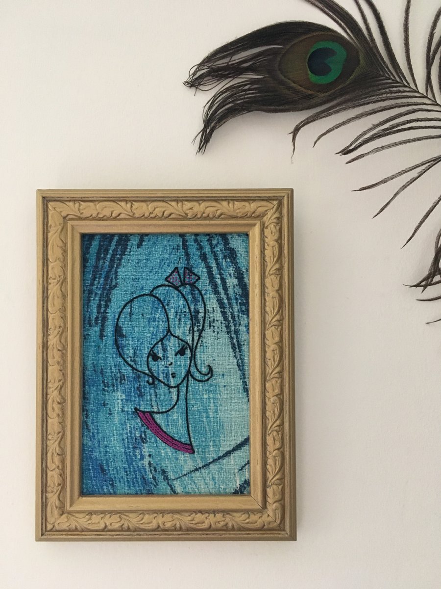 Hand Embroidered Girl on Vintage Blue Barkcloth Fabric in a Vintage Frame. 