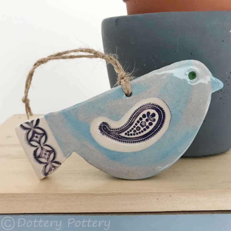 Ceramic bird decoration with patterned wing and tail 