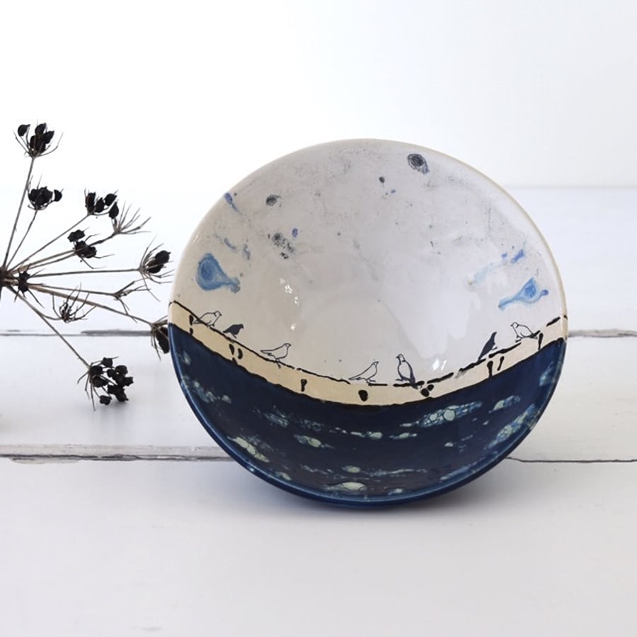 Handmade blue and white ceramic birds on a wire bowl - illustrated pottery