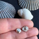 Mismatch pair of recycled silver stud earrings.