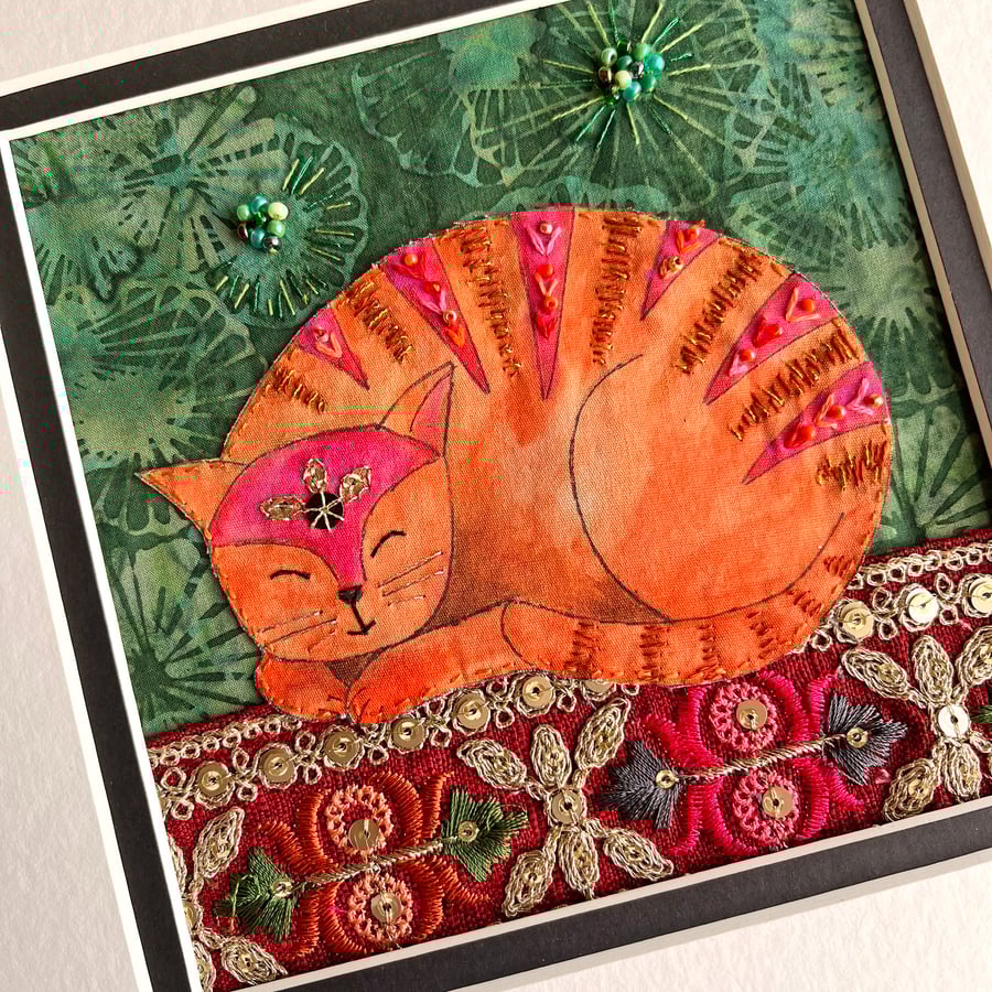 Textile artwork of cat, fabric cat art, whimsical cat picture, tabby cat