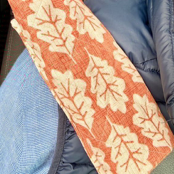 Pair of quilted seatbelt pads - oak leaves on russet background