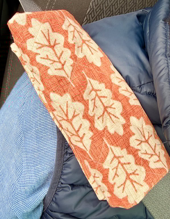 Pair of quilted seatbelt pads - oak leaves on russet background