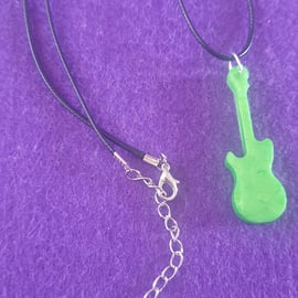 Green guitar pendant on black cord necklace