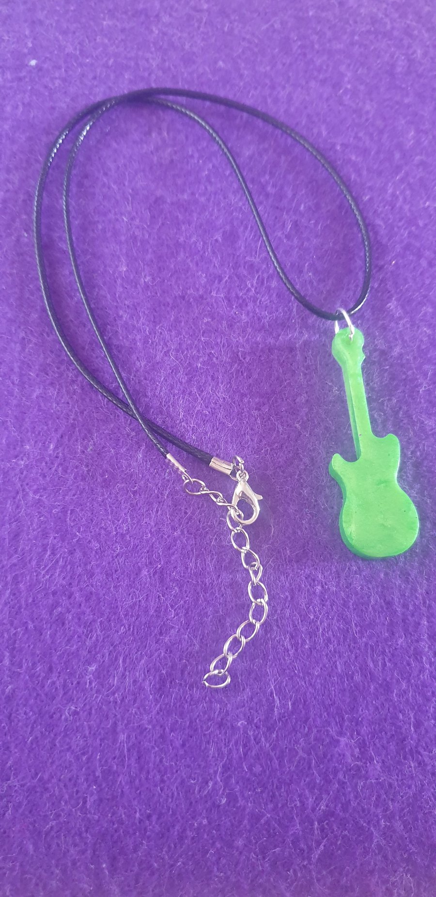 Green guitar pendant on black cord necklace