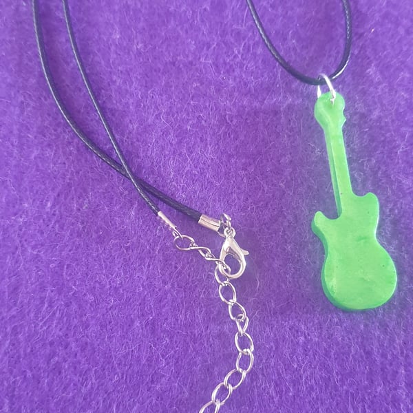 Green guitar pendant on black cord necklace