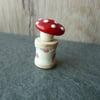 glass toadstool on wooden spool