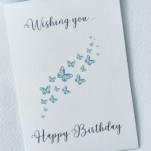 Wishing you happy birthday card with  a trail of blue butterflies