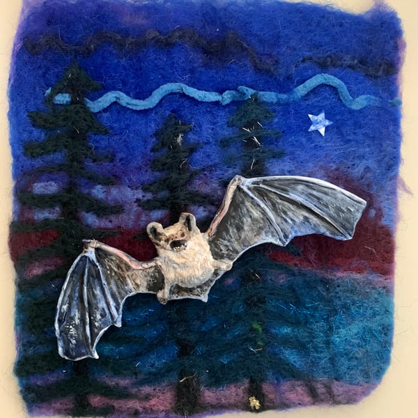 Long eared bat sculpture on a felted sky mounted in shadow box frame.