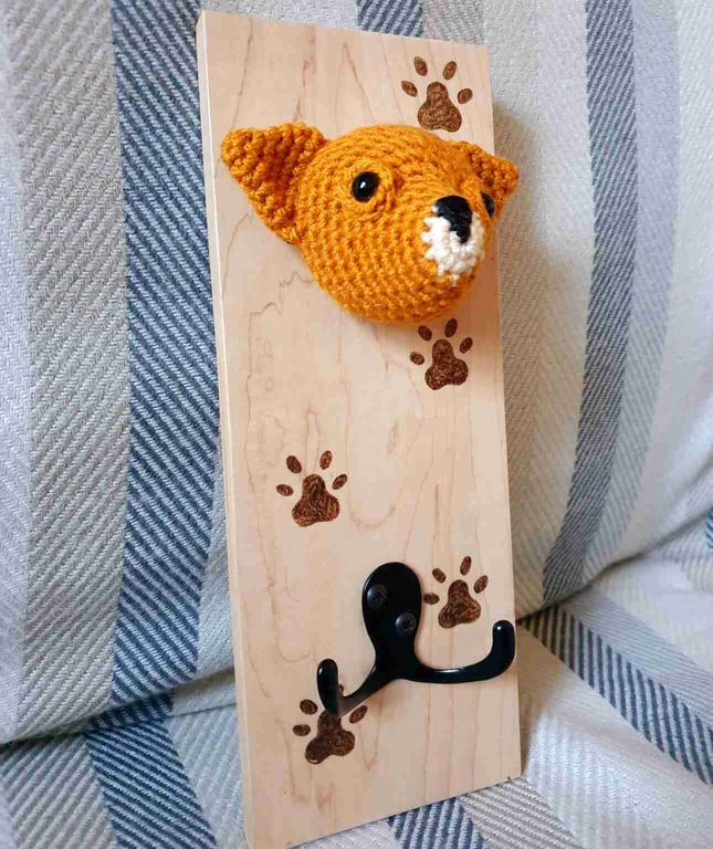Crocheted chihuahua head on wooden board with hooks