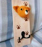 Crocheted chihuahua head on wooden board with hooks