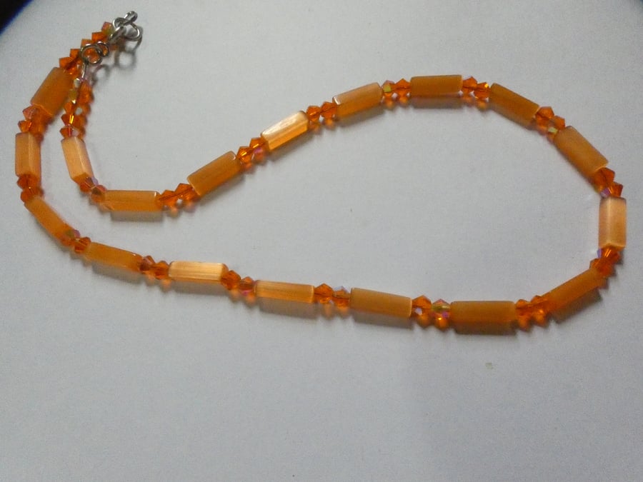 Vibrant orange cats eye and crystal bead single strand necklace