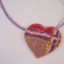 Embroidered love heart textile necklace with yarn and mixed fabrics