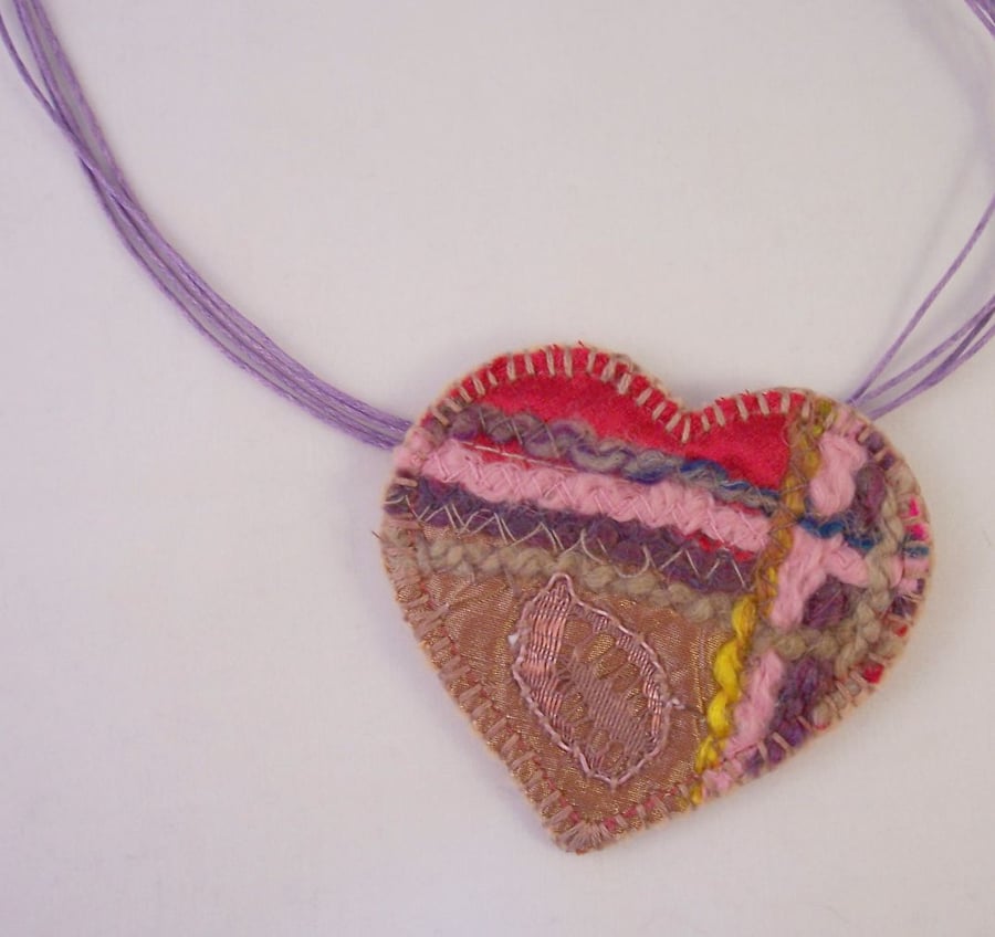 Embroidered love heart textile necklace with yarn and mixed fabrics