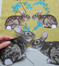 Handmade taupe-grey linen cushion with sewn printed rabbit & fluffy pompom tails - Image 3