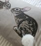 Handmade taupe-grey linen cushion with sewn printed rabbit & fluffy pompom tails - Image 2