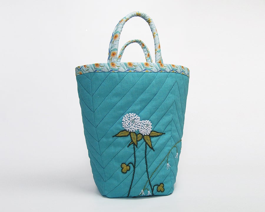 Large turquoise linen project bag with clover and bluebell embroidery