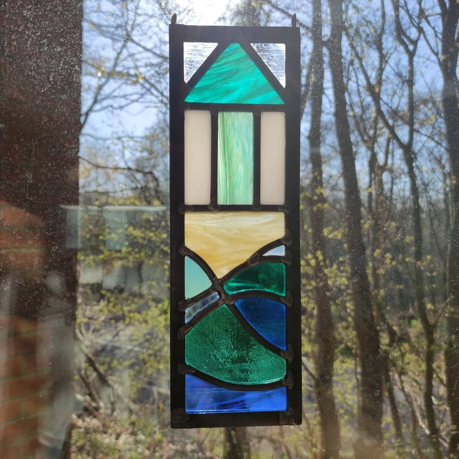 Stained glass single beach hut and sea leaded panel.