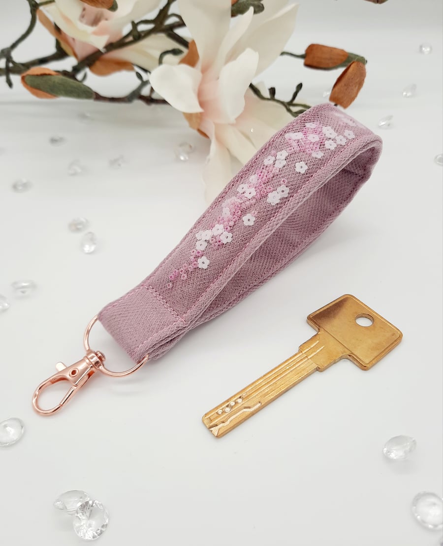 Pink wristlet bag charm, keyfob,  white flowers and seed beads. 