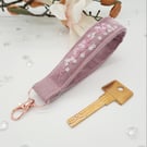 Pink wristlet bag charm, keyfob,  white flowers and seed beads. 