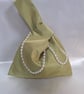 Olive green taffeta Japanese knot bag with pearl detailing.