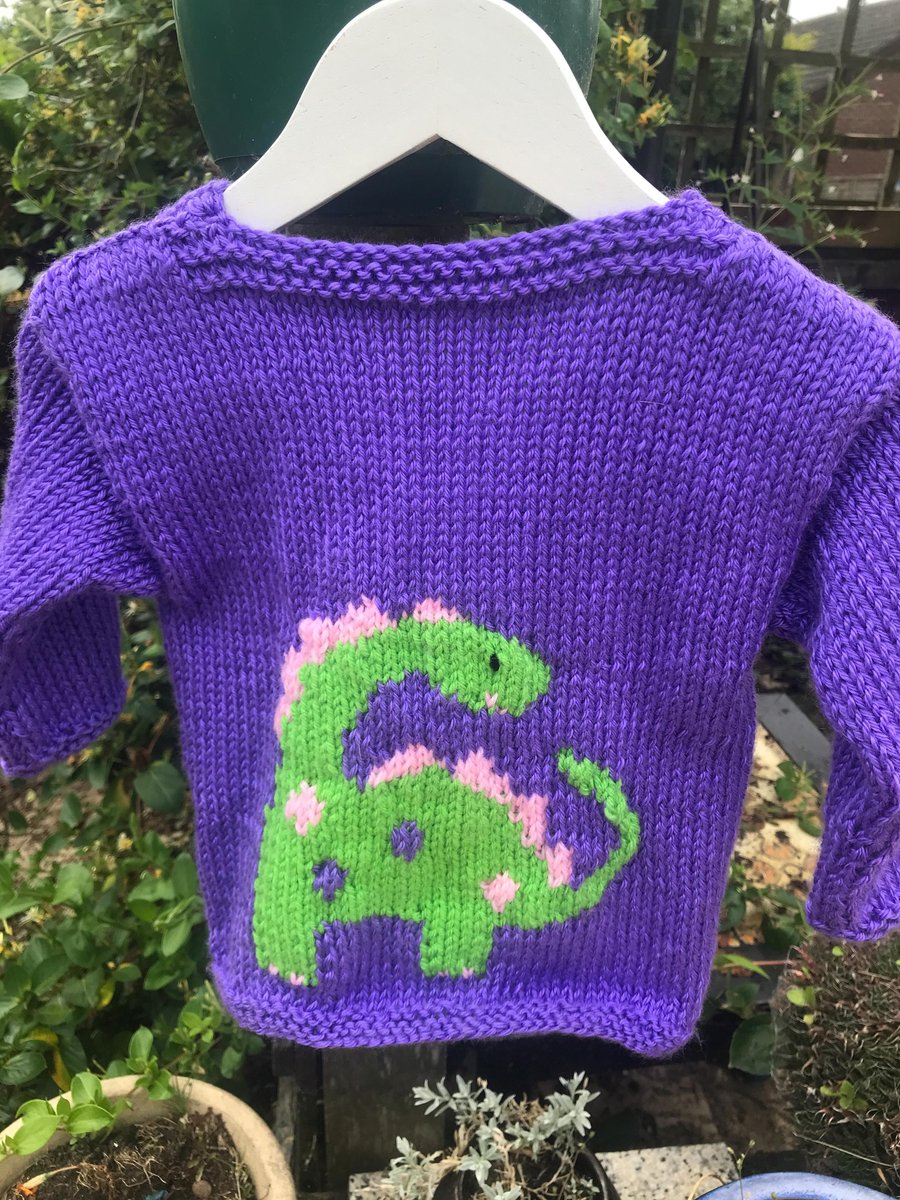 Hand knitted traditional baby cardigan ,purple dinosaurs. Girly 18 months