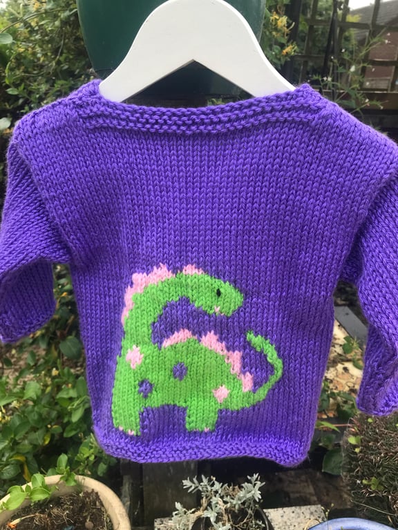 Hand knitted traditional baby cardigan ,purple dinosaurs. Girly 18 months