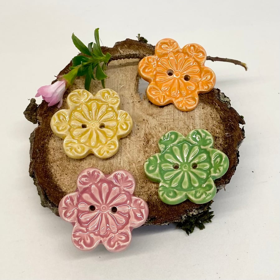 Set of four flower shaped ceramic handmade buttons brights
