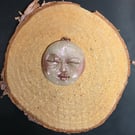 Hand sculpted moon face pendant