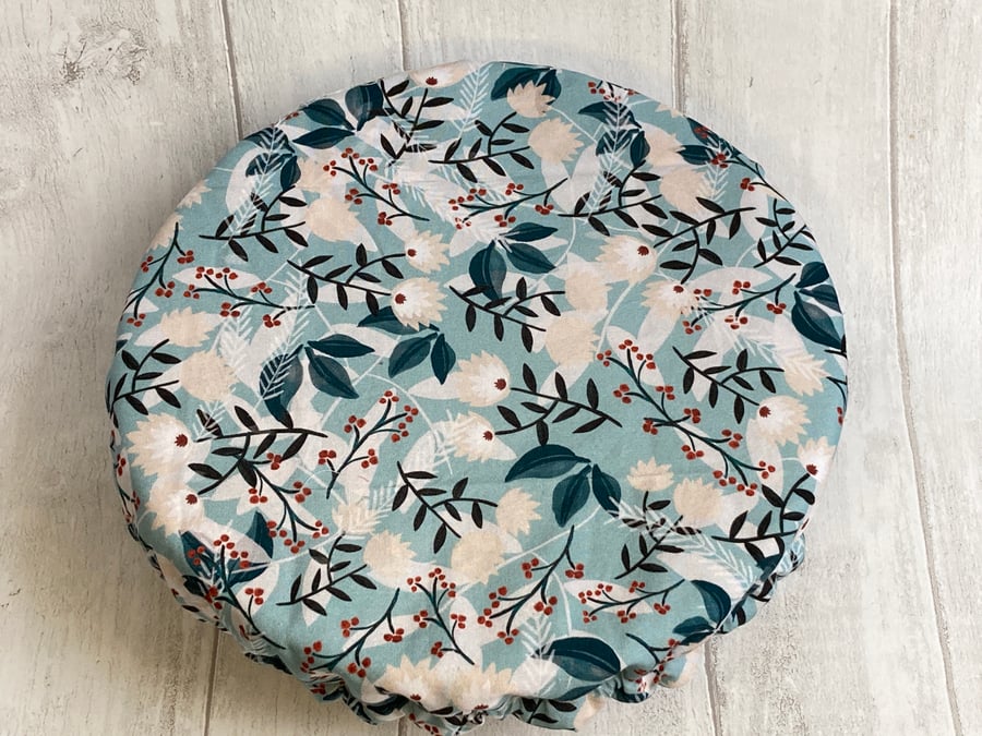 One extra large reusable bowl cover to fit a mixing bowl. Blue leaf design.