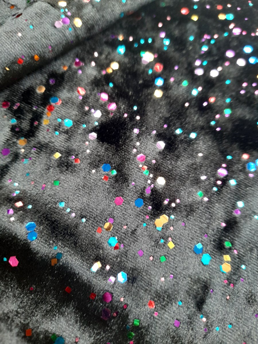 Black stretch velvet fabric with multi coloured foiled speckles