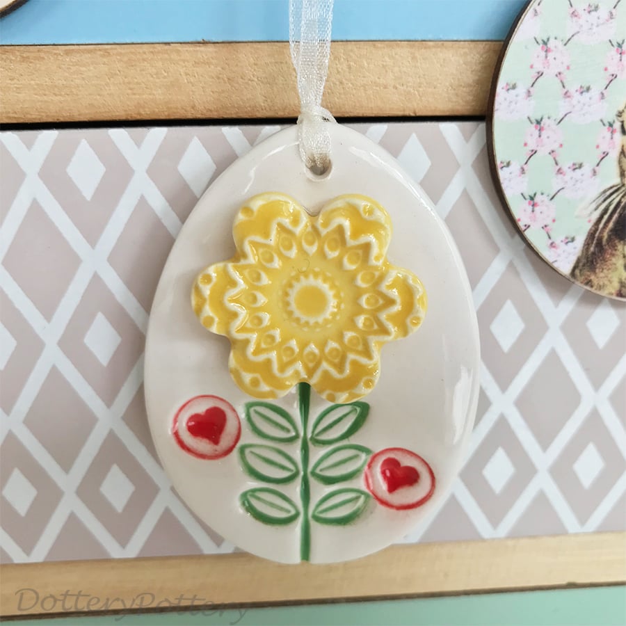 Pottery Easter Egg decoration with yellow flower