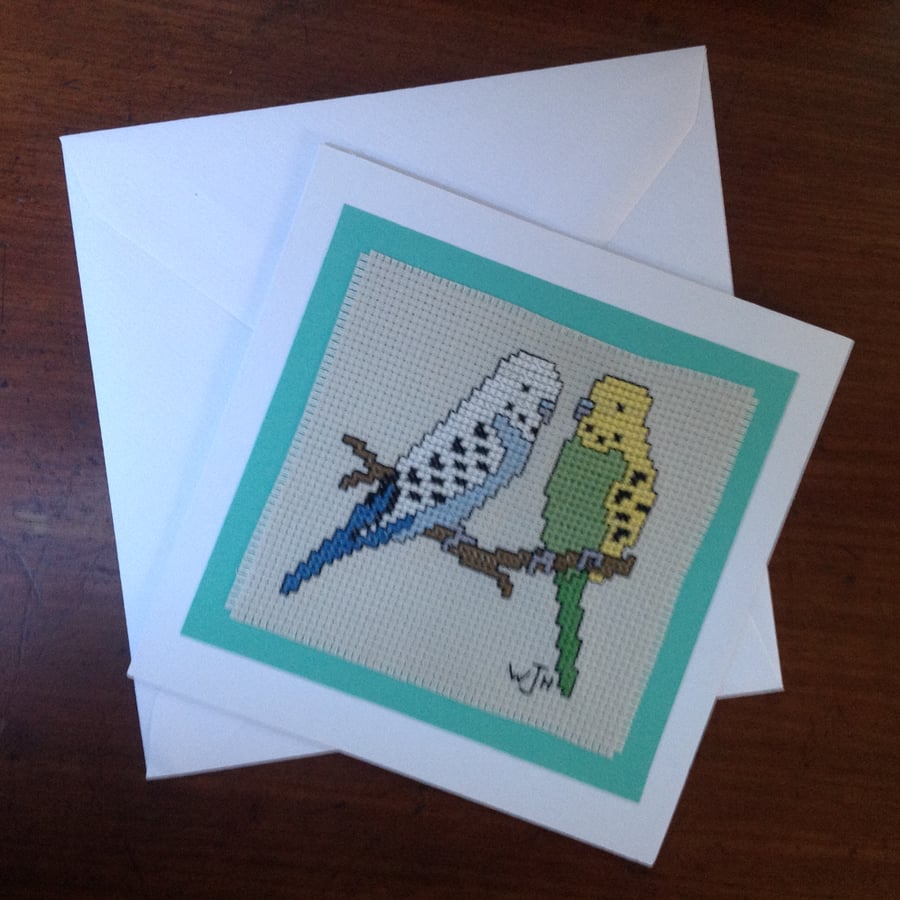 Handmade cross stitch greetings card of a pair of budgerigars