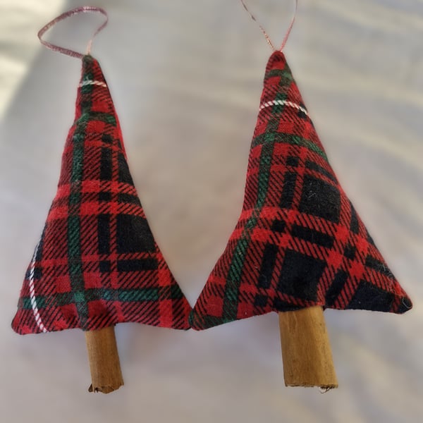 Pair of hand crafted fabric christmas tree decorations with cinnamon trunk