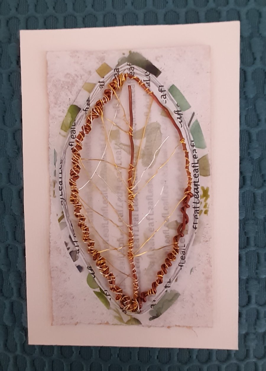 A Single Wire Leaf. Copper Gold Silver with Green Tones and White Artwork.