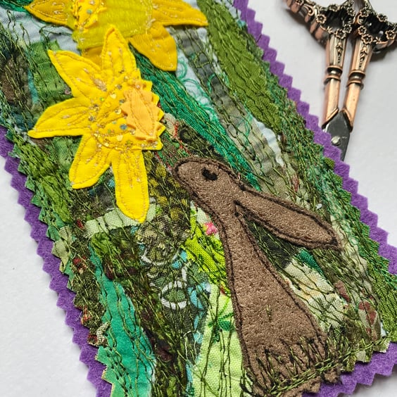 Upcycled embroidered spring rabbit and daffodil home decoration.