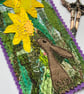 Upcycled embroidered spring rabbit and daffodil home decoration.