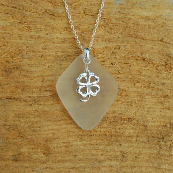 Beach glass pendant with lucky charm