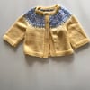 Hand knitted baby cardigan with a fair isle yoke