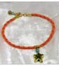 Bracelet Orange Faux Leather with gold plated Starfish charm bead. - Image 1