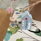 Teeny miniature wooden house and cotton reel
