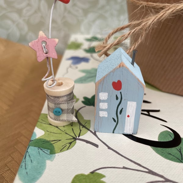 Teeny miniature wooden house and cotton reel