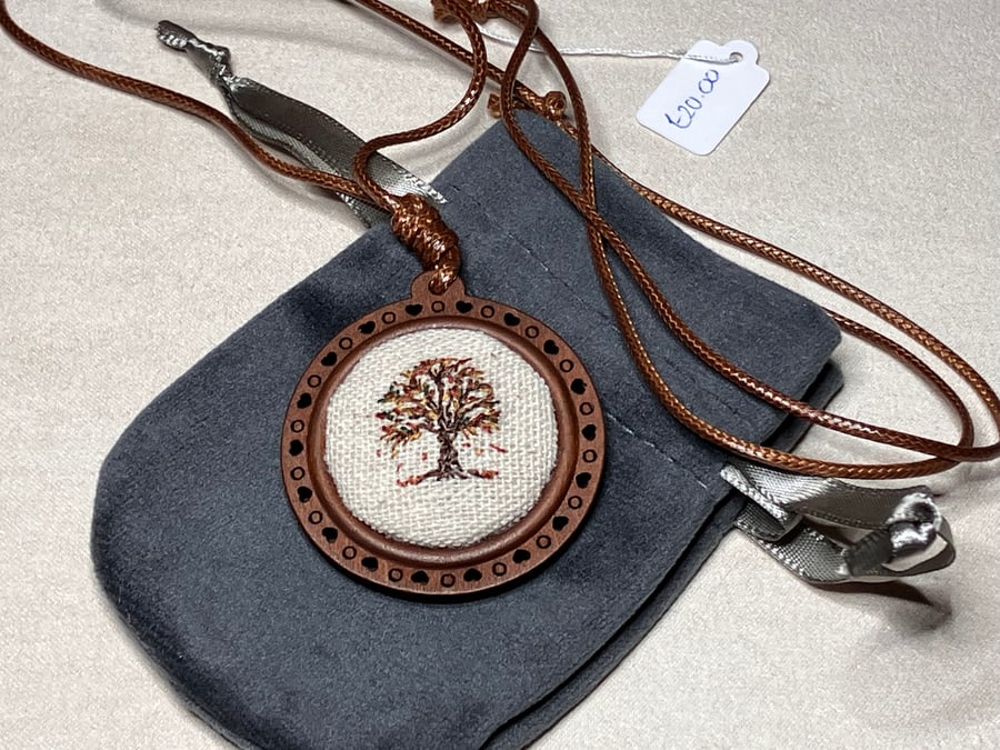 Hand embroidered tree pendant necklace.