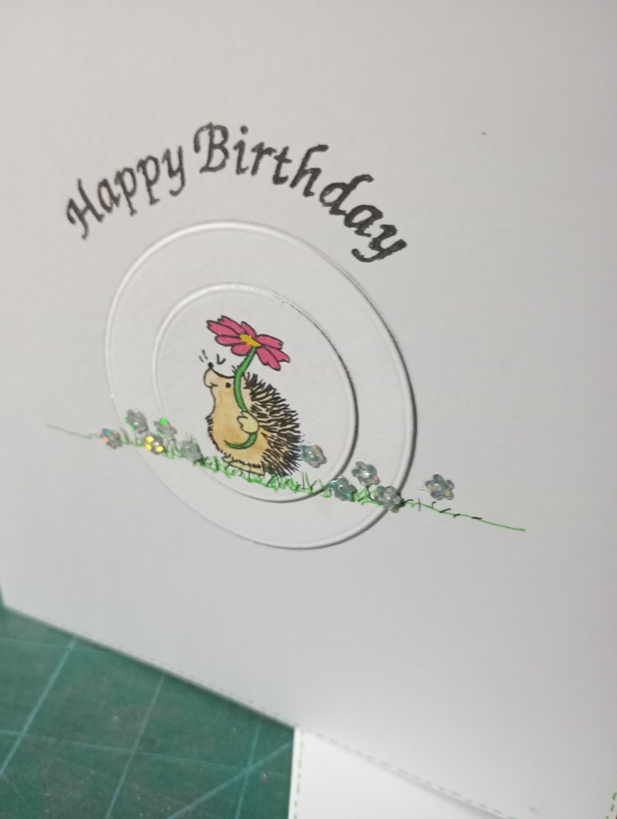 Cute hedgehog with single daisy birthday card