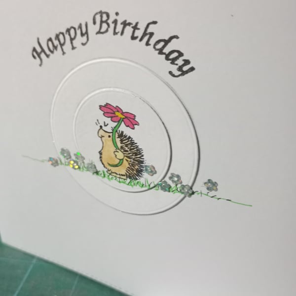 Cute hedgehog with single daisy birthday card