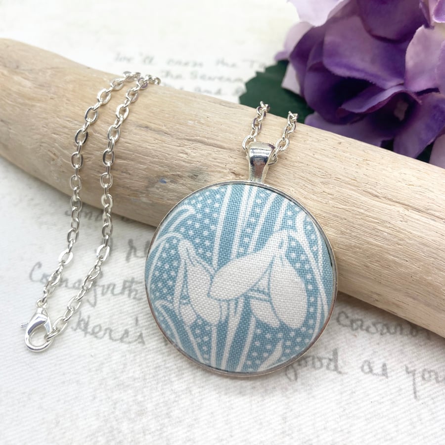 Snowdrop in soft blue fabric button pendant Art Nouveau silver plated finish