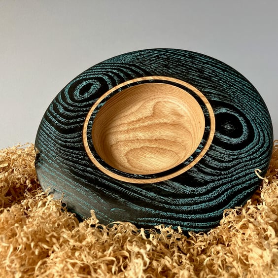 Small hand-turned wooden platter with vibrant aqua grain detail.