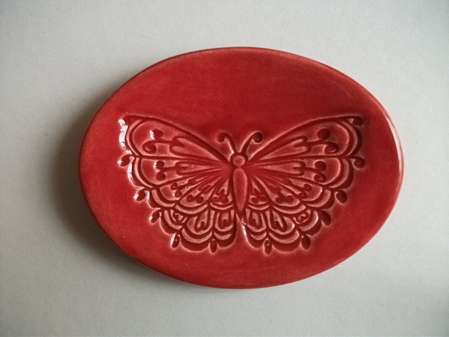 Ruby red ceramic trinket dish impressed with a butterfly design