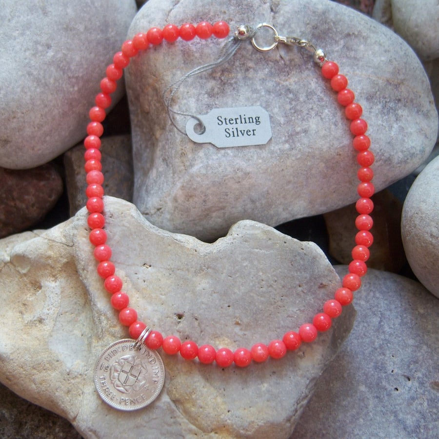 Coral ankle bracelet with silver threepence coin charm